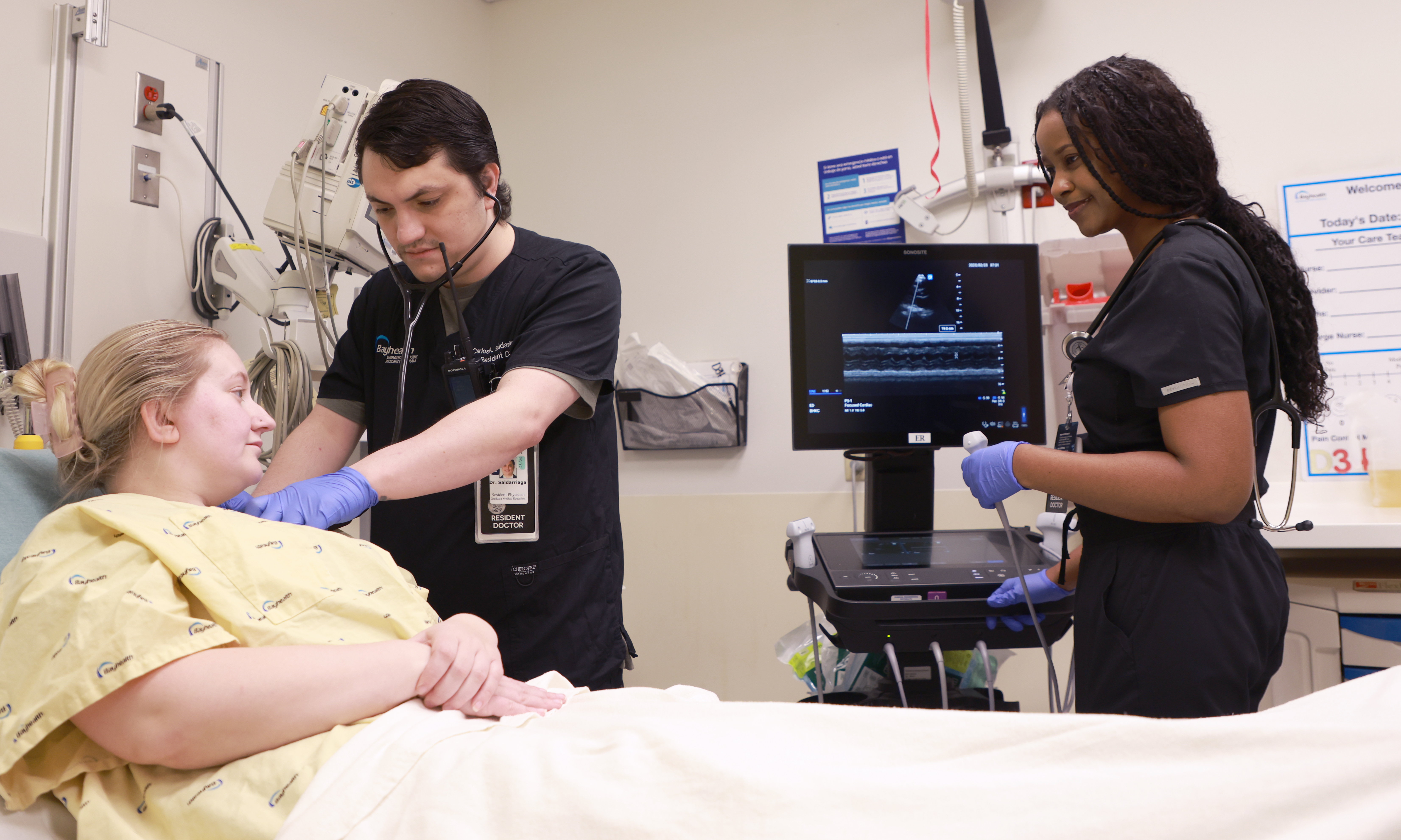 Two emergency medicine residents caring for a patient