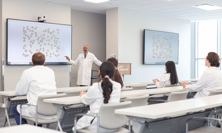 Hematology Oncology fellows listen to lecture from faculty member