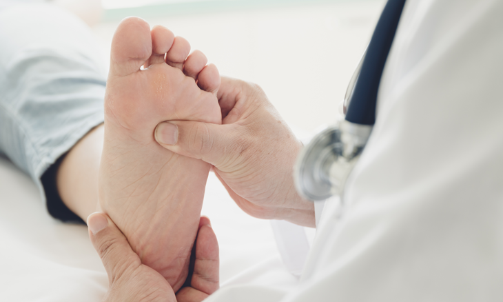 Physician checking diabetic patients foot