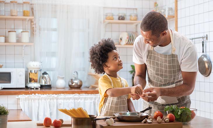 Dad cooking with son.