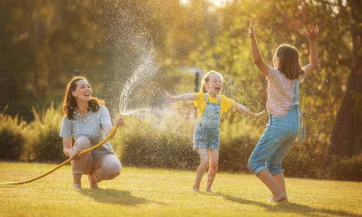 A mom playing with her children outside