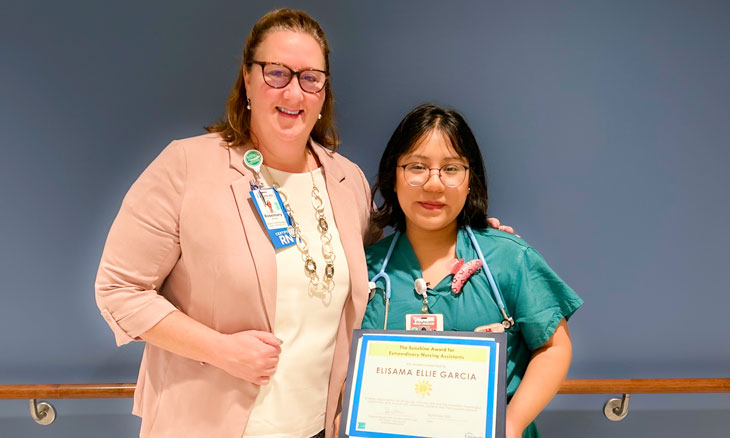 From left to right are Rosmary (Rosi) Wurster, DNP, RN, MPH, NEA-BC, CEN, and Elisama (Ellie) Garcia, CNA,  with her Sunshine Award